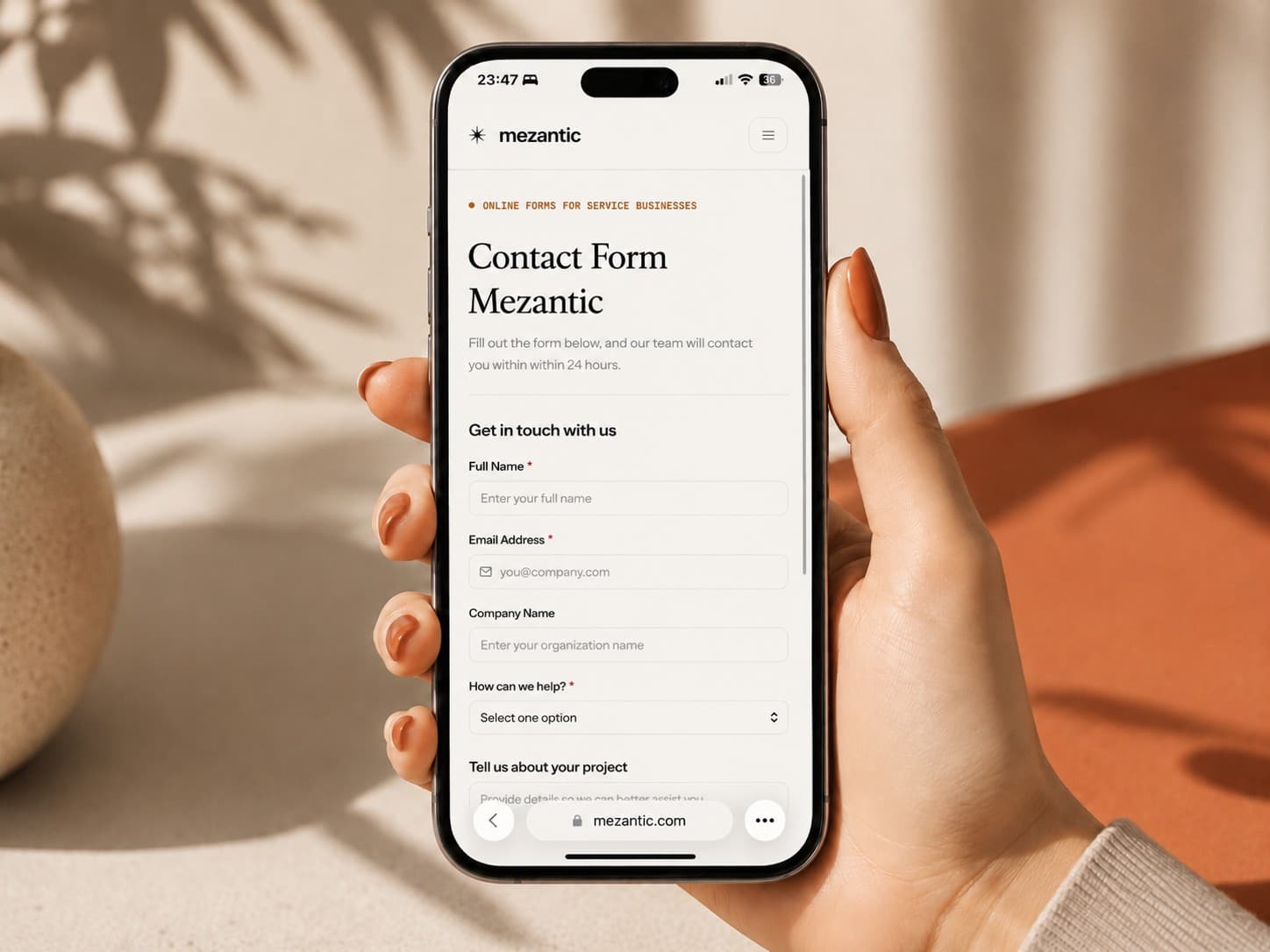 A Mezantic contact form open on a phone held in hand